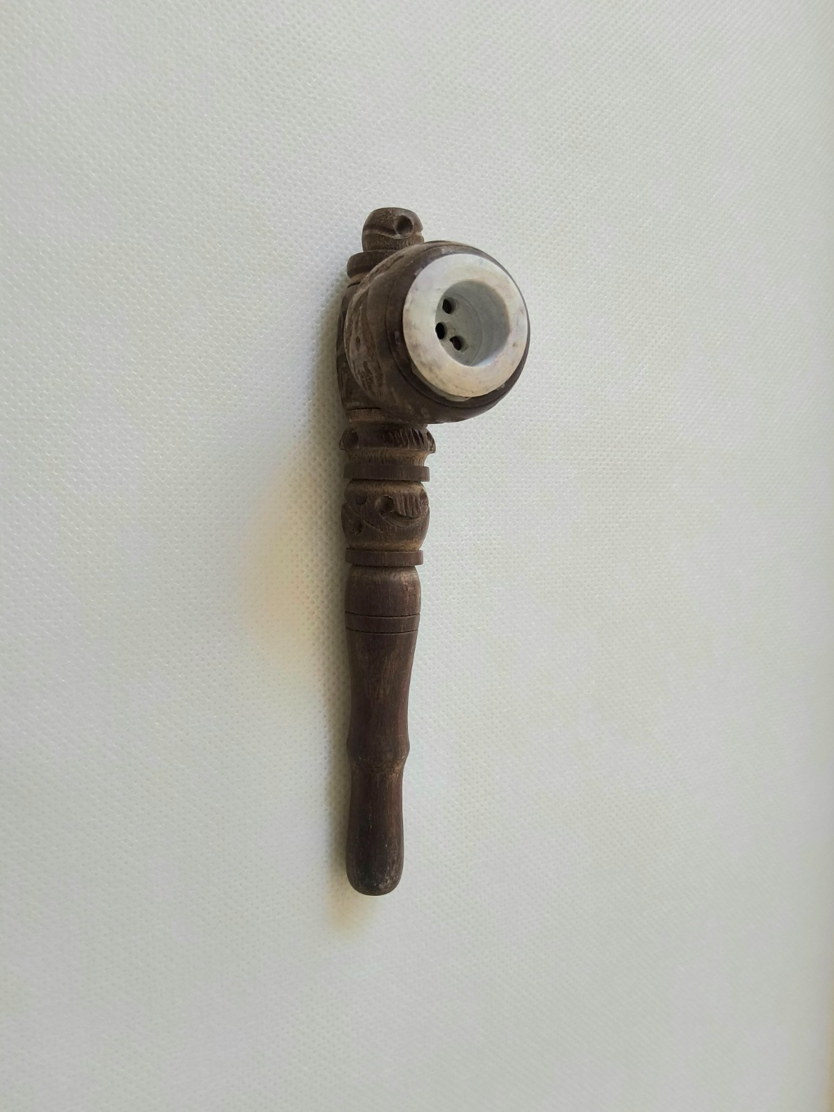 “Handcrafted Wooden Smoking Pipe with Intricate Carvings