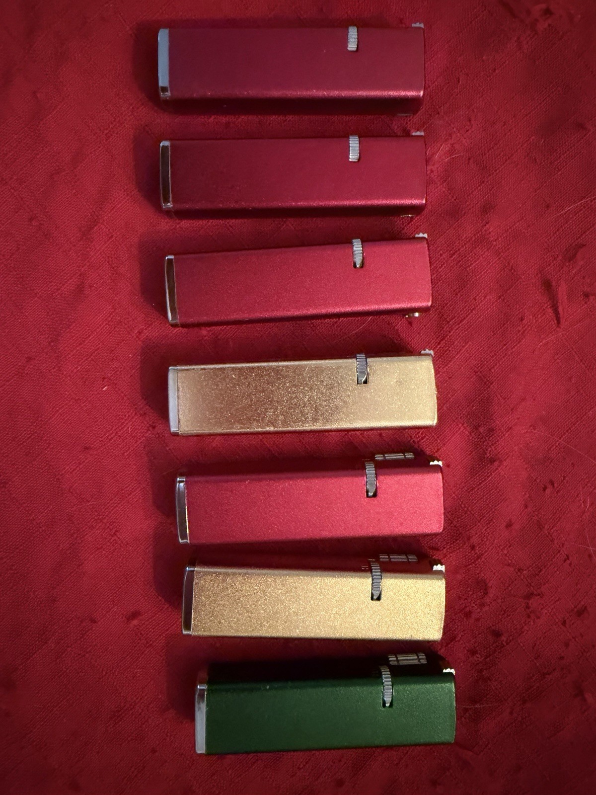 Lot of 7 Vintage JJJ Super Thin Slim Gas Pocket Lighters Gold Red and Green.