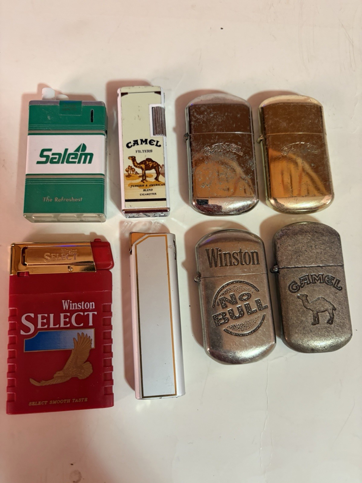 EIGHT Different Collectable Cigarette Lighters – Used but Works