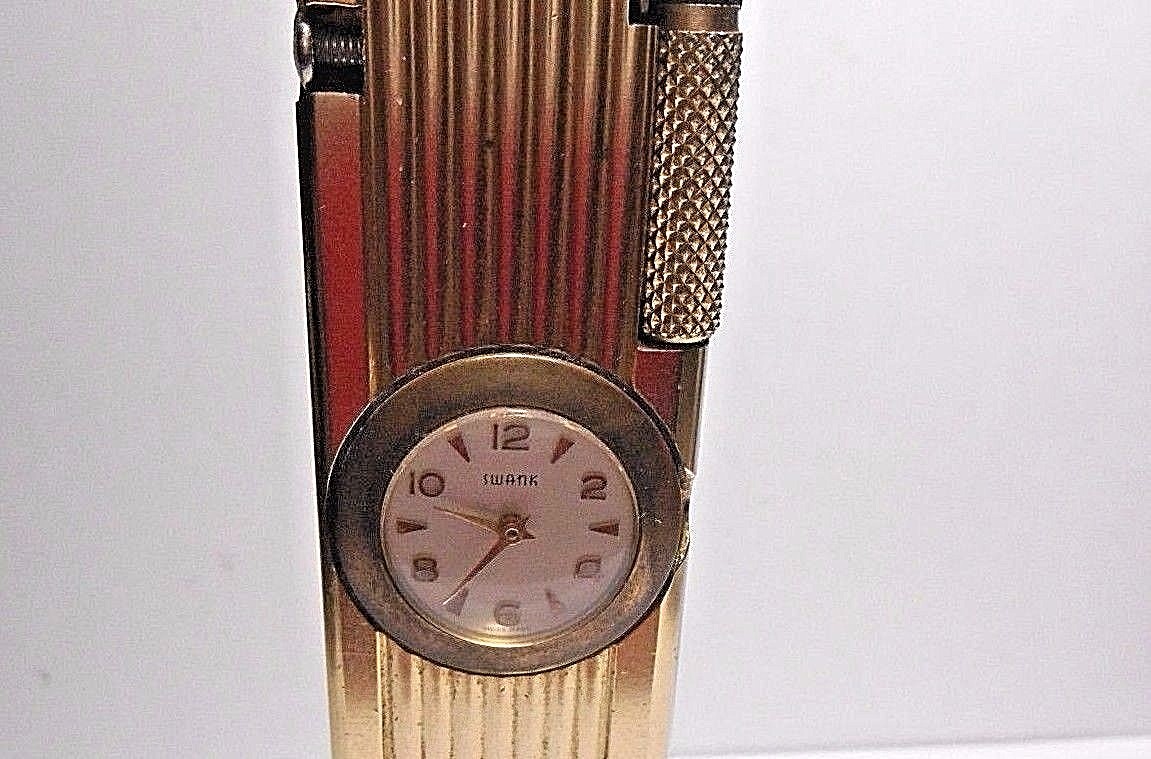 VINTAGE CYGNUS LIFT ARM TABLE LIGHTER WORKS WITH SWANK CLOCK. WIND STEM MISSING