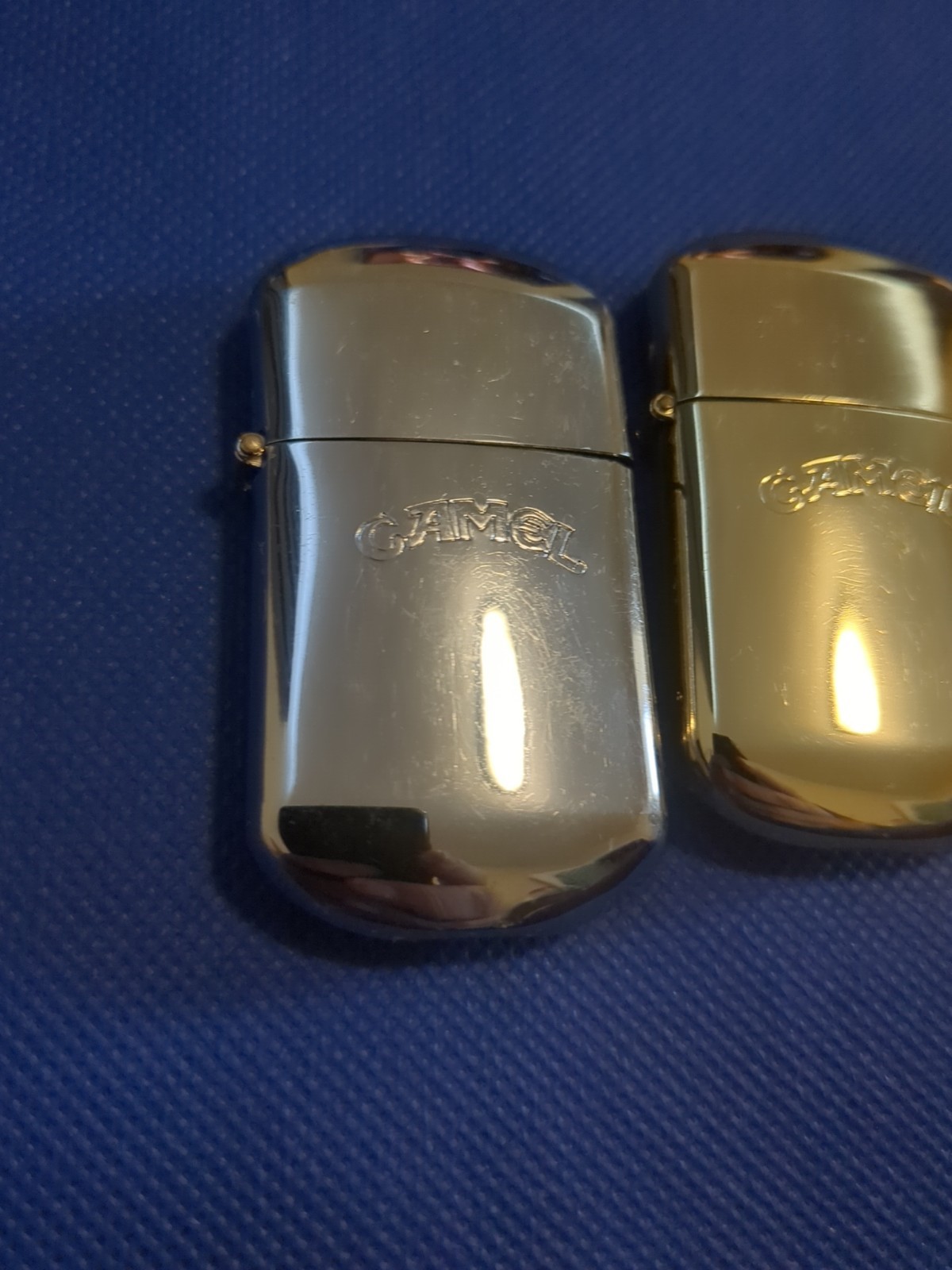 LOT OF 2 VINTAGE CAMEL BRANDED METAL FLINT LIGHTERS SILVER AND GOLD NEVER USED