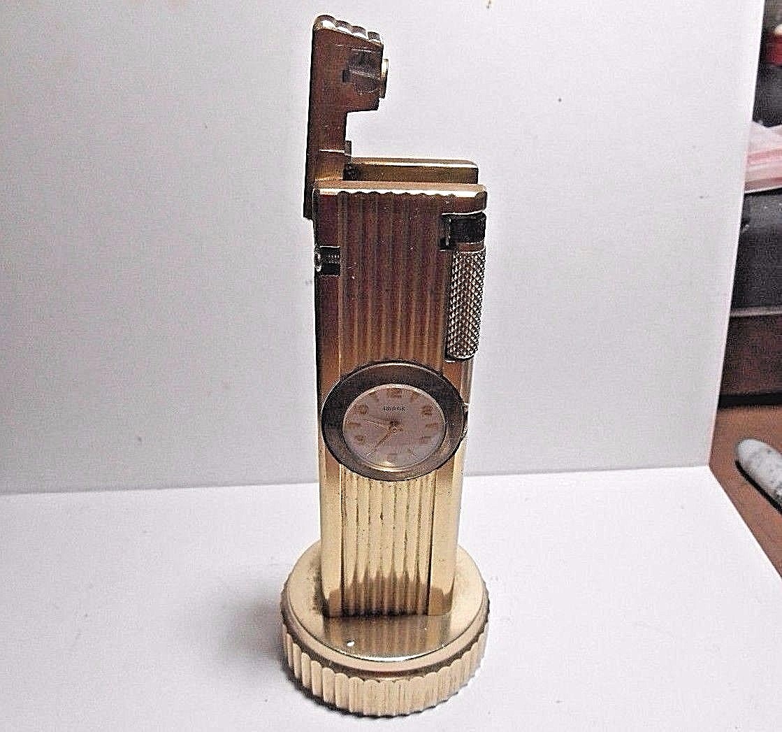 VINTAGE CYGNUS LIFT ARM TABLE LIGHTER WORKS WITH SWANK CLOCK. WIND STEM MISSING
