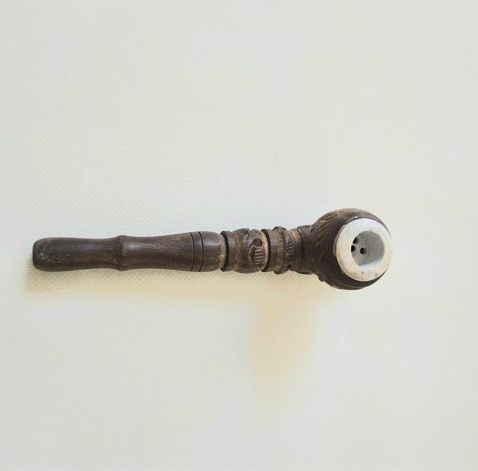 “Handcrafted Wooden Smoking Pipe with Intricate Carvings