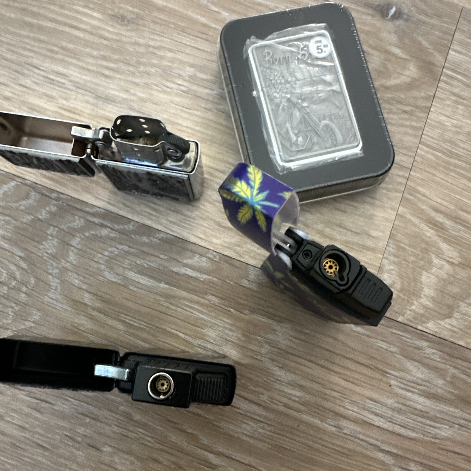 A set of 4 lighters with a pattern.