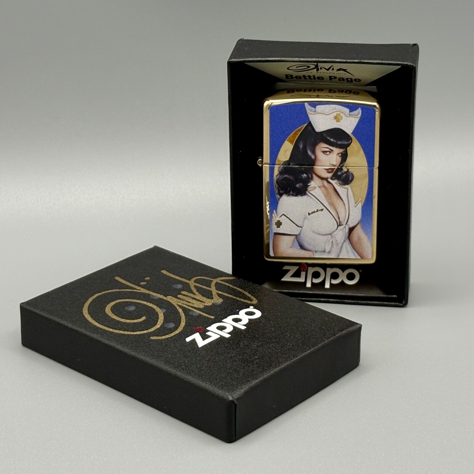 Olivia Zippo Bettie Page Nurse in Gold with Signed Box