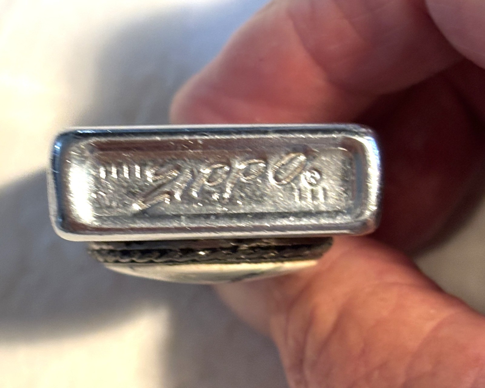 Zippo ligher with raised emblem of horse, slim