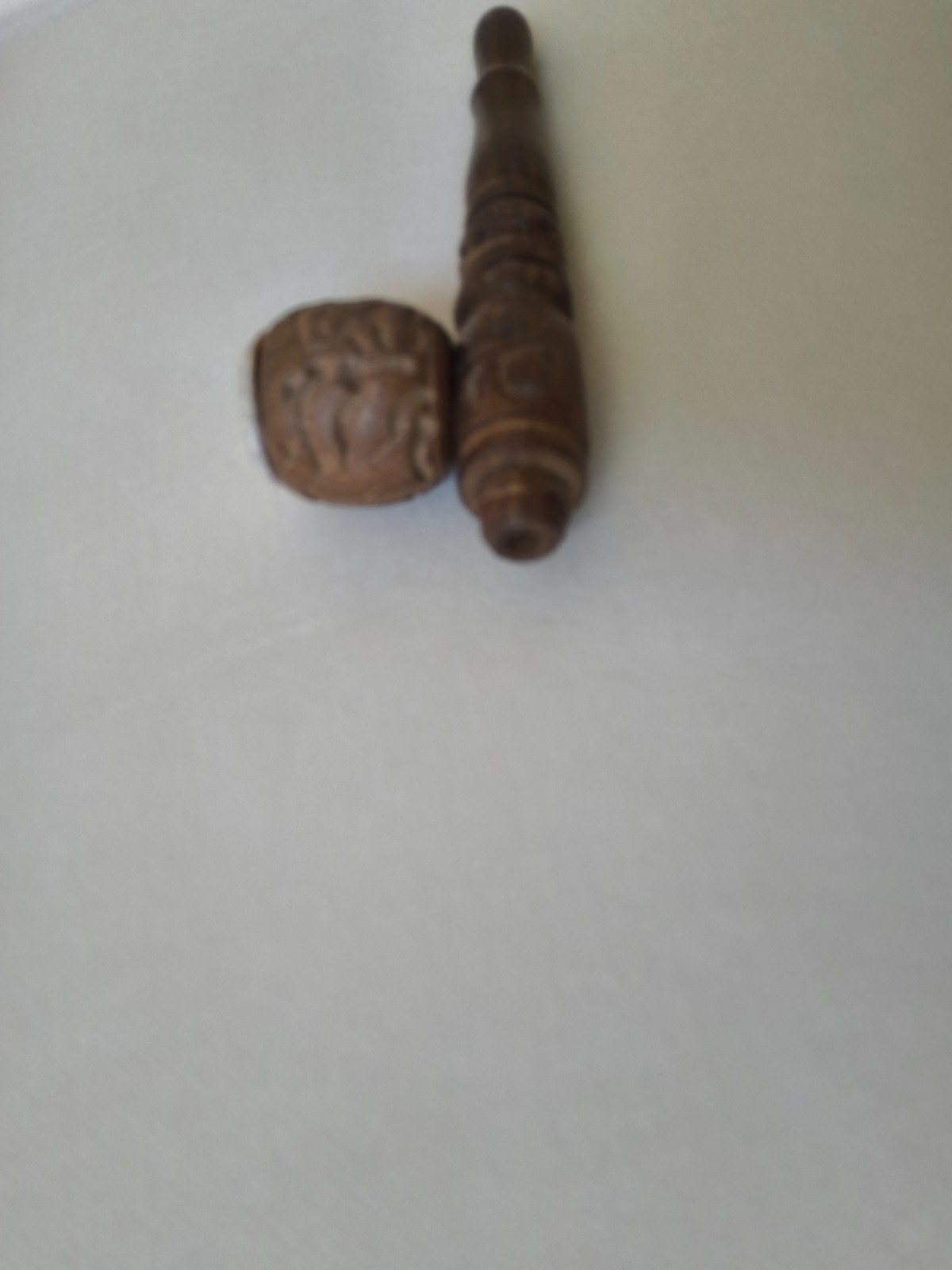 “Handcrafted Wooden Smoking Pipe with Intricate Carvings