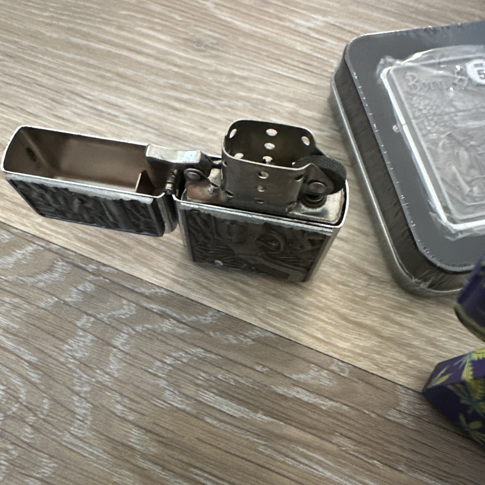 A set of 4 lighters with a pattern.